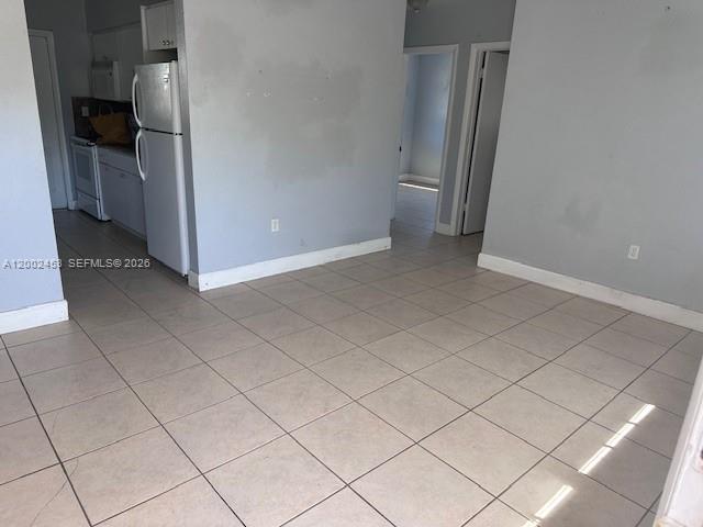 3723 Northwest 23rd Avenue, Unit 2 Miami, FL 33142 - Photo 2 of 8 a view of a refrigerator in kitchen and an empty room