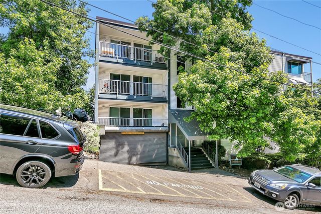 a front view of a house with parking space