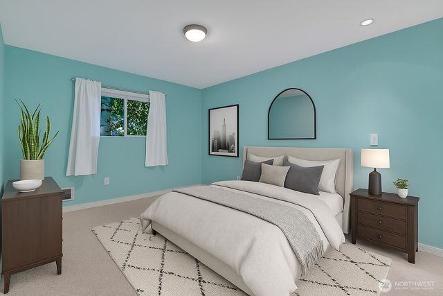 a bedroom with a bed and a painting on the wall