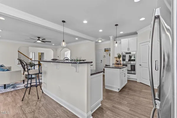 a kitchen with stainless steel appliances granite countertop a sink a stove and a refrigerator