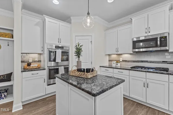 a kitchen with sink stove and cabinets