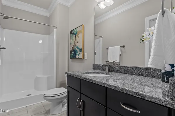 an empty room with a window and a ceiling fan