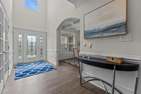 an empty room with a window and a ceiling fan