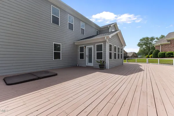 a view of a house with potted plants and a fountain