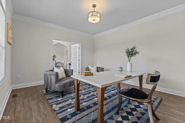 a view of a dining room with furniture and chandelier