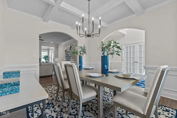 a view of a dining room with furniture a chandelier and wooden floor