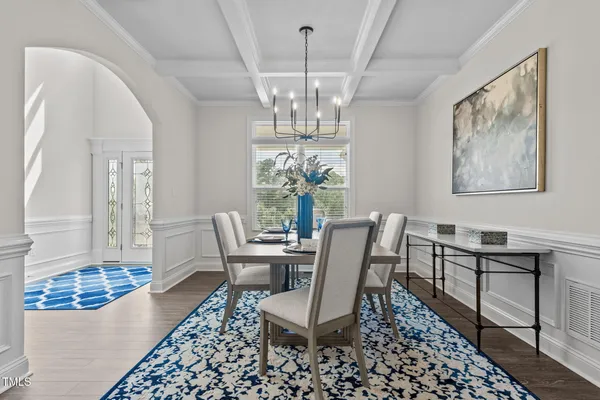 a living room with furniture a fireplace and a large window