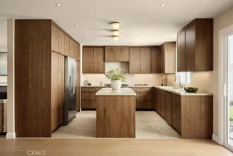 a kitchen with kitchen island cabinets and refrigerator
