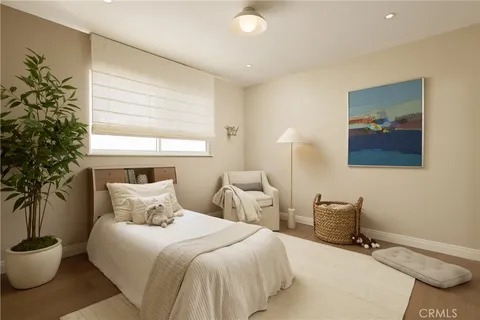 a bedroom with a bed and a potted plant