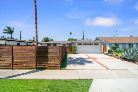 a front view of house with a garden