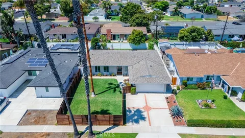 an aerial view of multiple houses with a yard