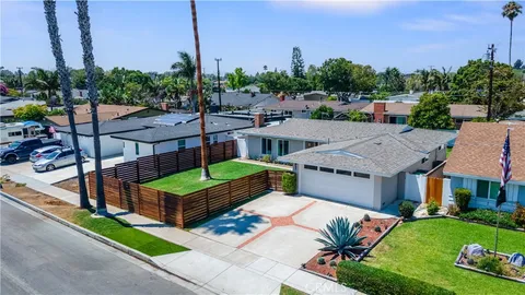 a view of a house with yard and sitting area