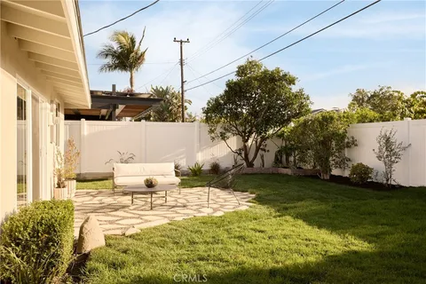 a view of a patio with a table and chairs