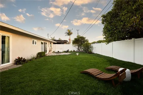 a view of a white house with a yard