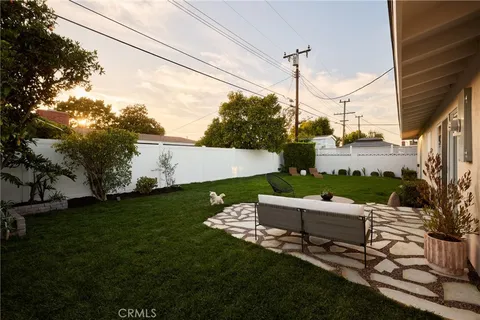 a view of a chair and table in backyard