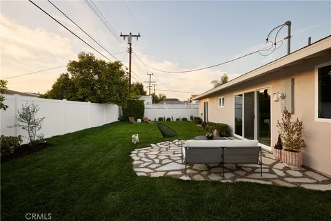 a view of a patio with table and chairs potted plants