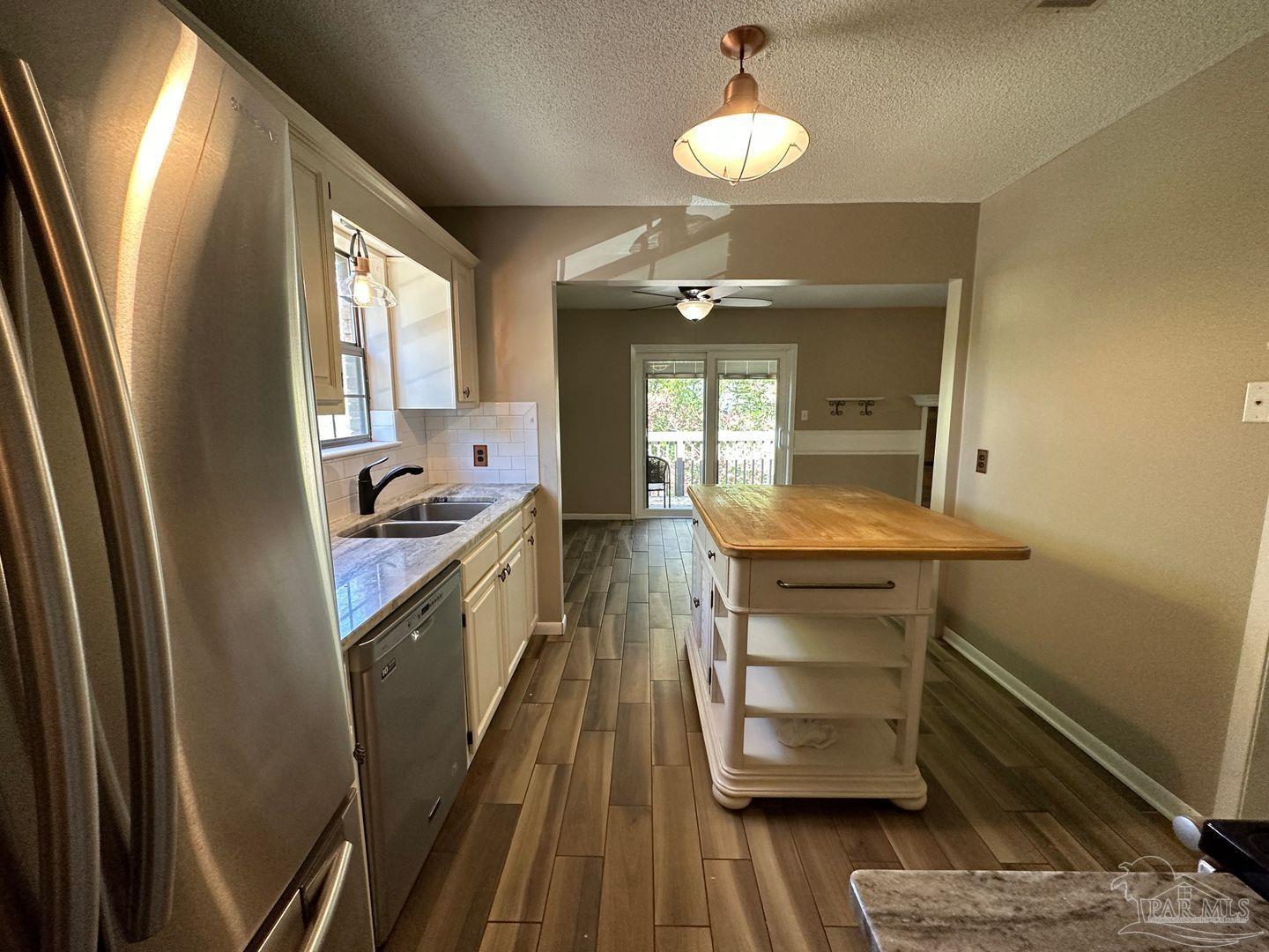 4831 East Olive Road, Unit 4D Pensacola, FL 32514 - Photo 5 of 17 a kitchen with a sink and wooden floor