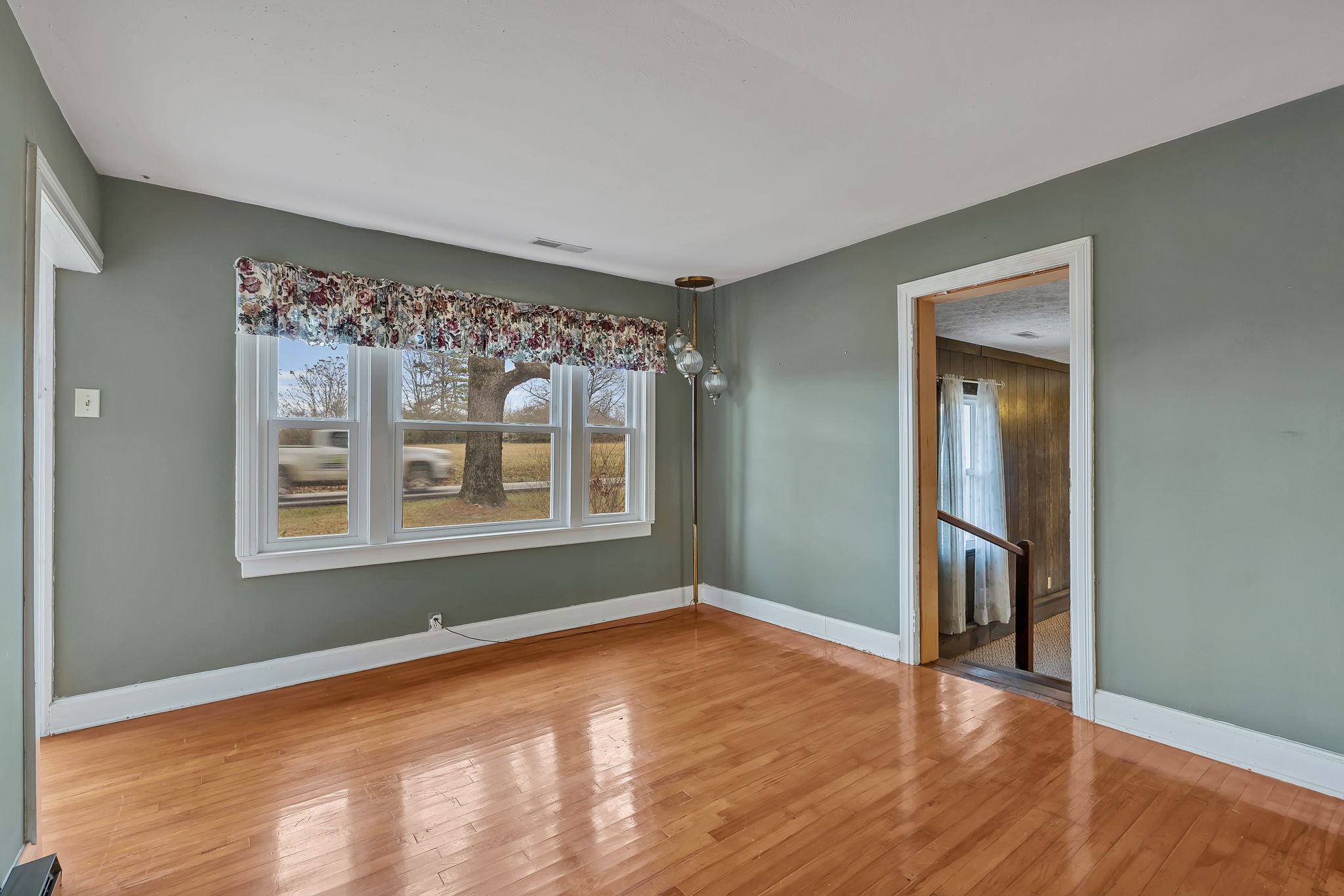 7203 Old Franklin Road Fairview, TN 37062 - Photo 8 of 43 a view of an empty room with wooden floor and a window