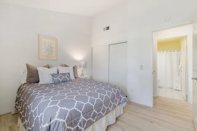 a large bed sitting in a bedroom next to a bathroom