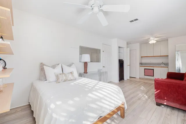 a spacious bedroom with a bed and a fireplace