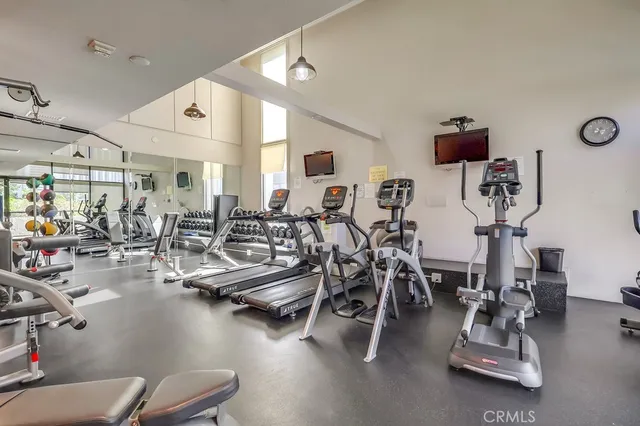 a view of a swimming pool with a bench and trees in the background