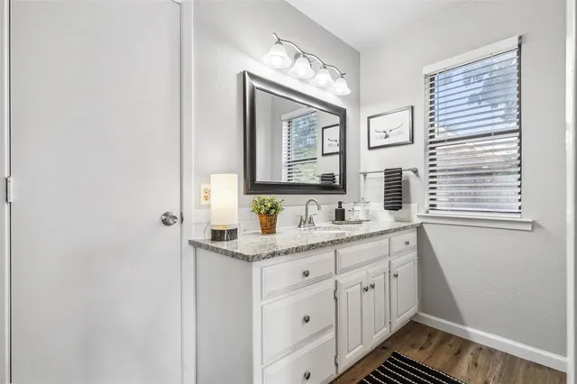 a bathroom with a double vanity sink and a mirror