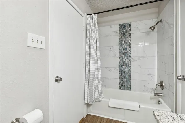 a bathroom with a shower curtain and a window