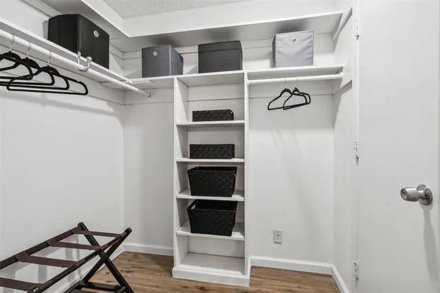 a view of walk in closet with empty racks