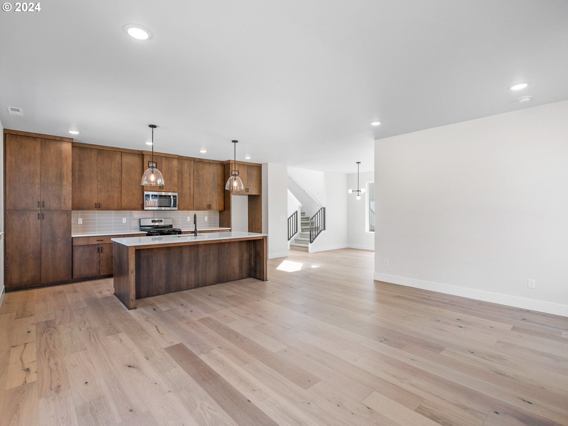 16911 Southeast Siri Loop Damascus, OR 97089 - Photo 4 of 21 a large kitchen with a large counter top a sink stainless steel appliances and cabinets