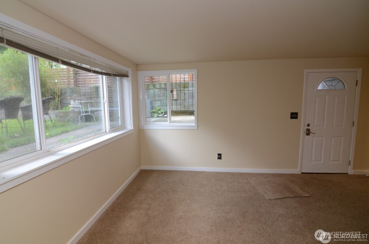 1409 Northwest 65th Street, Unit 3 Seattle, WA 98117 - Photo 5 of 23 an empty room with a window