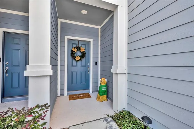 a view of kitchen with wooden floor and electronic appliances