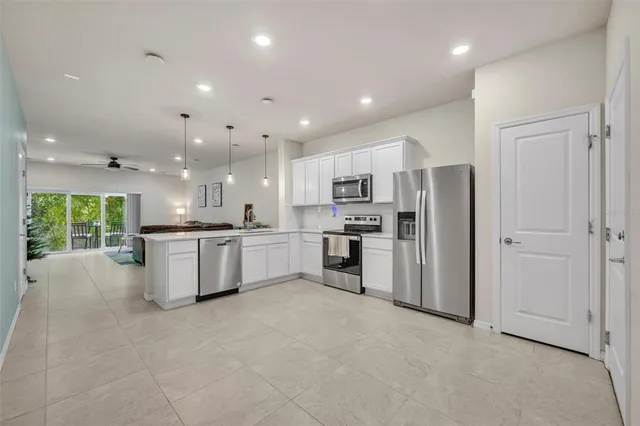 a view of a kitchen with white cabinets