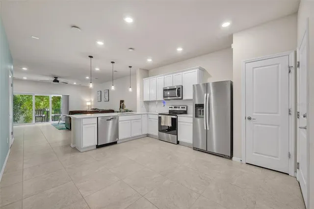 a kitchen with appliances a sink and cabinets