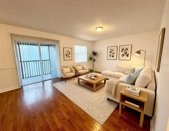 a living room with furniture rug and wooden floor