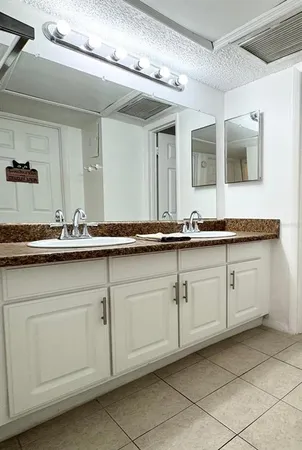 a bathroom with a sink and mirror