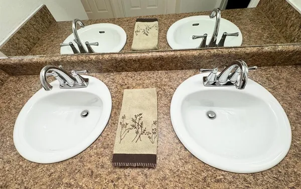 a white toilet and tub sitting next to a bathroom sink
