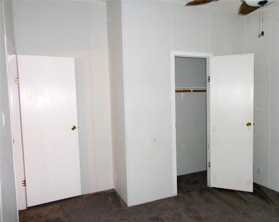 5525 Cedar Oaks Road Grandview, TX 76050 - Photo 19 of 40 Interior room with neutral wall paneling and dark gray carpeting