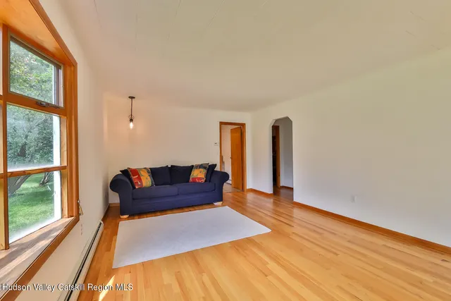 a bedroom with a bed a table and bookshelf