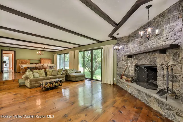a living room with couch and wooden floor