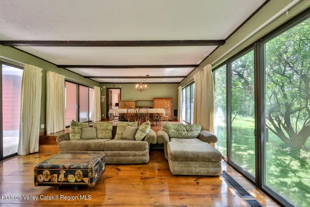 a view of empty room with wooden floor and fireplace