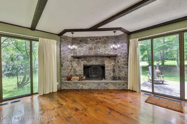 a view of a porch with wooden floor and furniture