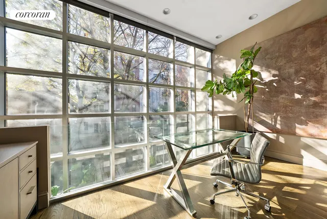 a living room with furniture a large window and a fireplace