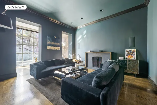 a living room with furniture and a book shelf