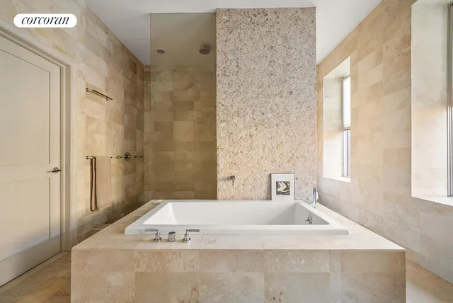 a spacious bathroom with double vanity a large mirror a bathtub and a shower