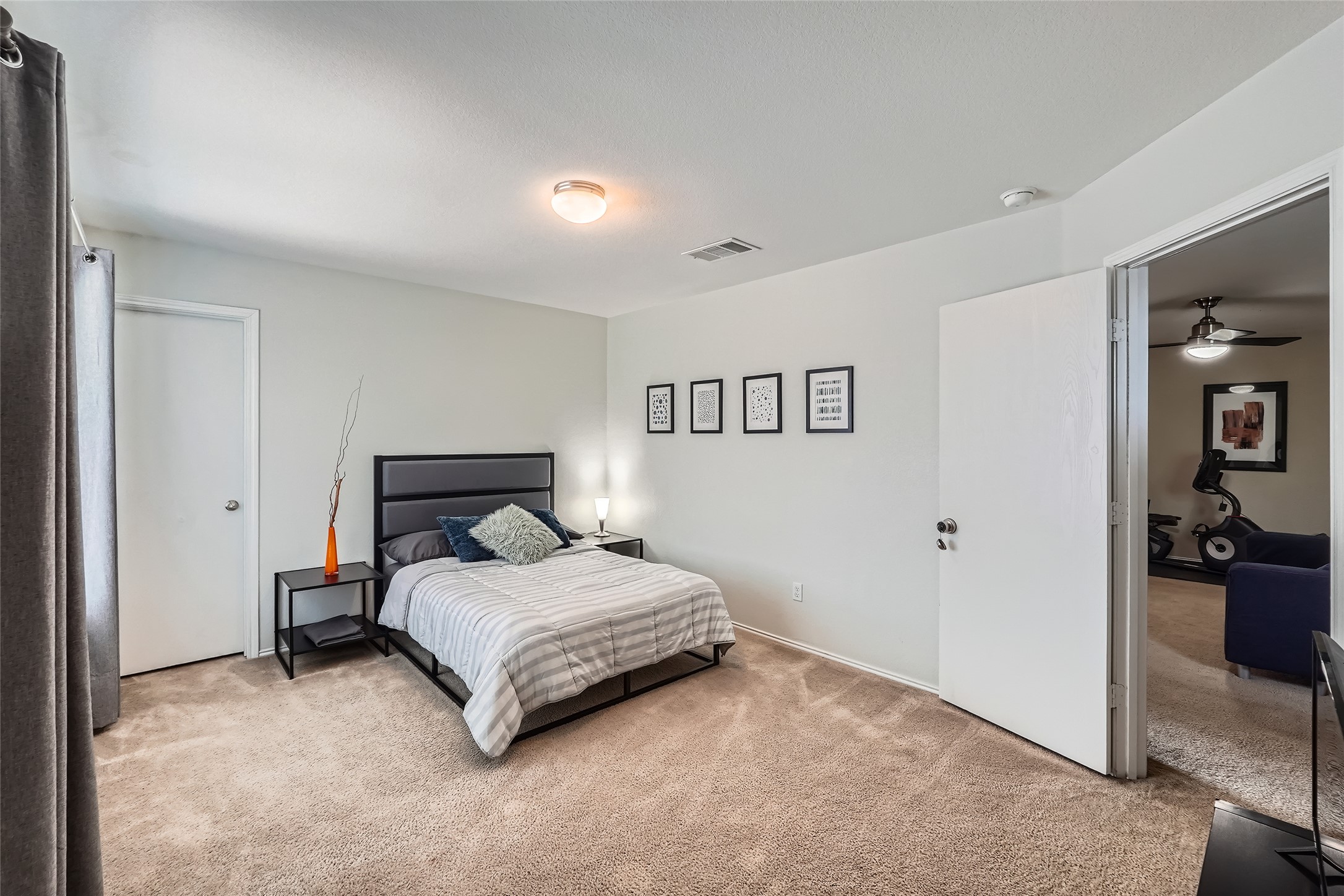 18021 Prairie Verbena Lane Elgin, TX 78621 - Photo 12 of 33 A well-appointed sleeping area boasts comfortable carpeting and convenient direct access to a separate room.