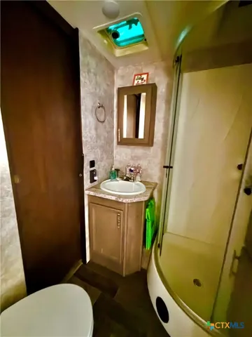 a bathroom with a sink toilet and shower
