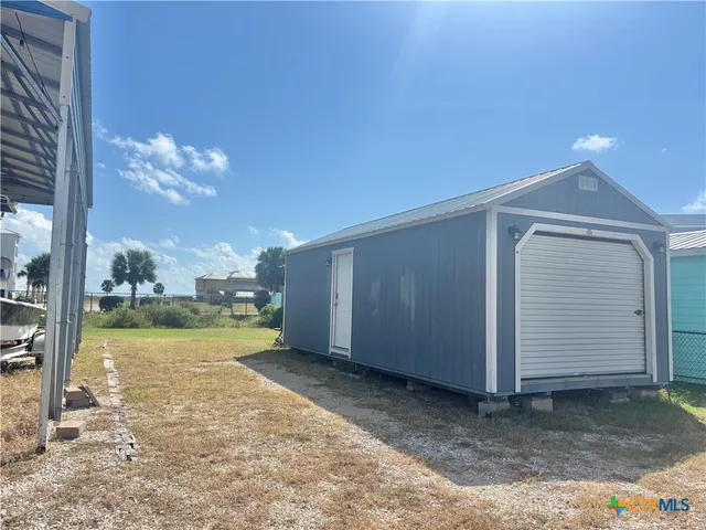a view of a room with a kitchen