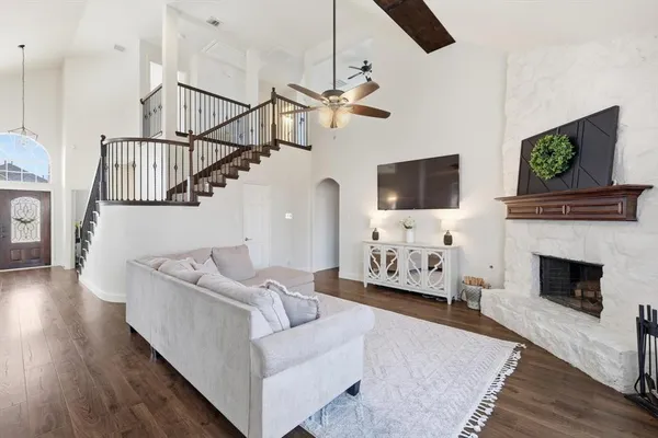 a living room with furniture a flat screen tv and a fireplace