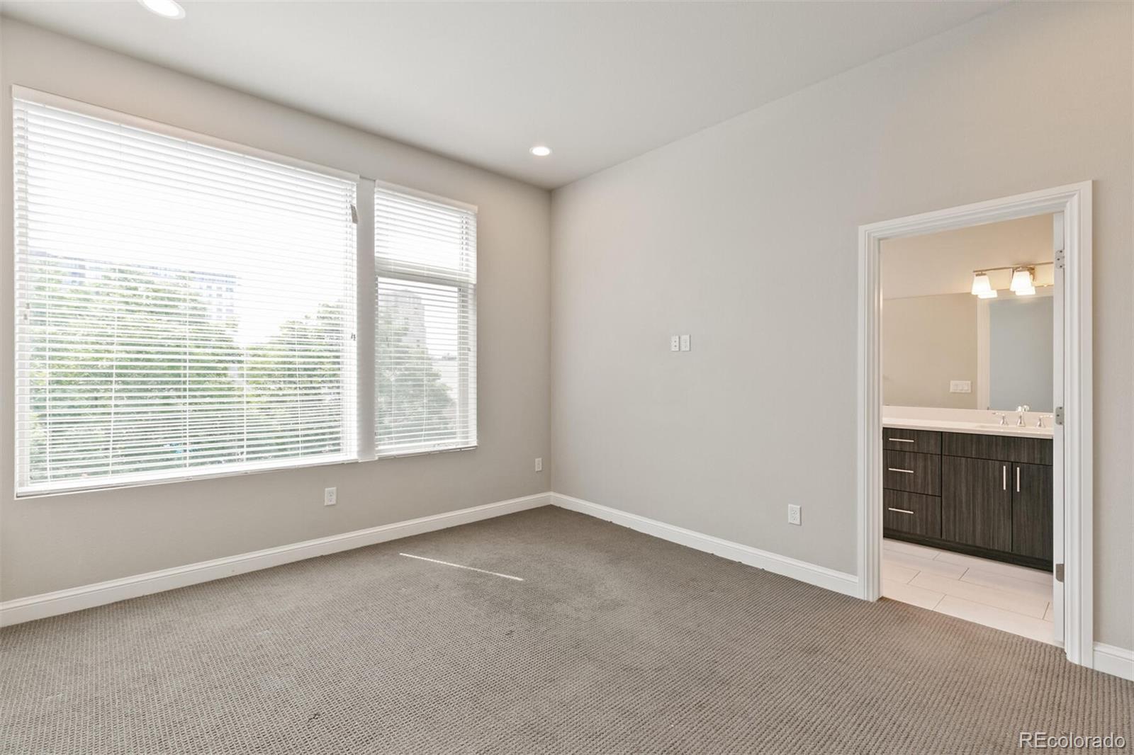 1014 Acoma Street Denver, CO 80204 - Photo 21 of 35 a view of an empty room with a window and a kitchen