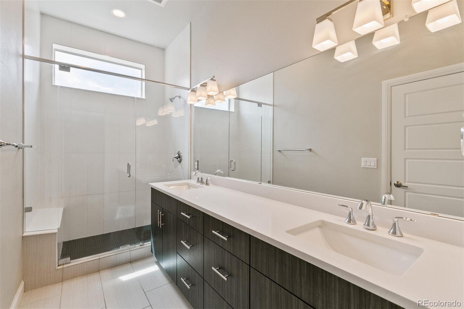 1014 Acoma Street Denver, CO 80204 - Photo 22 of 35 a bathroom with a double vanity sink mirror and double
